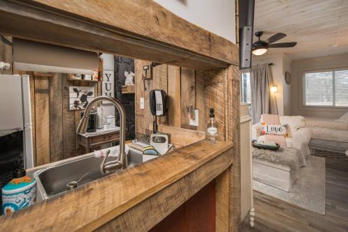 a kitchen and living room in a tiny house at Beech Mountain Studio - Trails, Concerts & Bike Park in Beech Mountain
