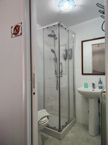 a bathroom with a shower and a toilet and a sink at B&B Palazzo Antonelli in Monopoli