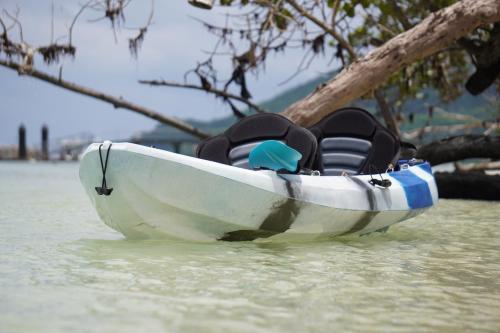 a small white boat sitting in the water at Surf Tropical Villa Seascape in Cerf Island