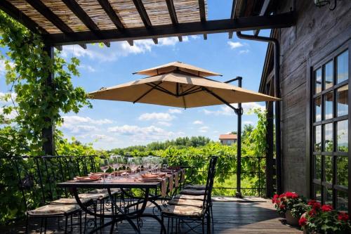 a patio with a table and an umbrella at Rooms Bolfan Vinski Vrh in Hrašćina