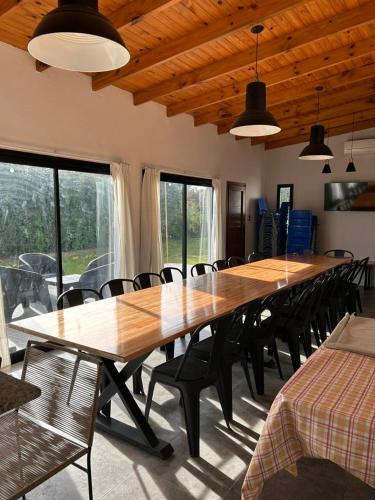 a large wooden table in a room with chairs at Quinta Las Lilas in Chivilcoy