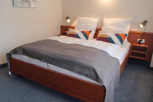 a bedroom with a large bed with two pillows at Haus Marquet in Saint-Vith