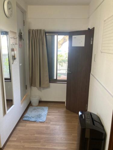 a room with a hallway with a door and a window at Vivi House in Kyoto