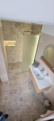 a bathroom with a sink and a mirror at Ubytování Chadimovi in Šluknov