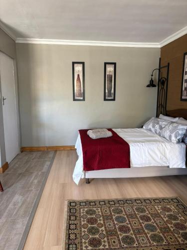 a bedroom with a bed with a red blanket at StayComfy on Jasmin in Oakdale