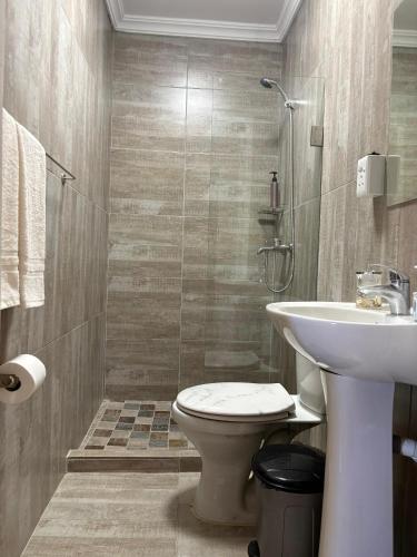 a bathroom with a toilet and a sink at StayComfy on Jasmin in Oakdale