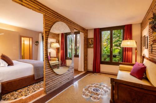 a bedroom with a bed and a mirror at Cinqueteste Luxury Home in Venice