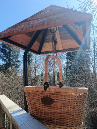 a picnic basket hanging from a picnic table at Chalets et cabane perchée "Ô Cœur des Puys" in Ceyssat