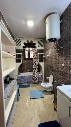 a bathroom with a toilet and a sink in it at Villa Barba Luxor in Luxor