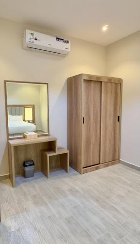 a room with a vanity and a mirror at Alturya in Al-ʿUla