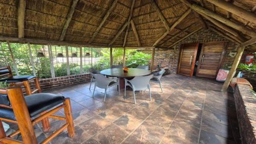 a patio with a table and chairs in a building at Midvaal Guesthouse in Meyerton