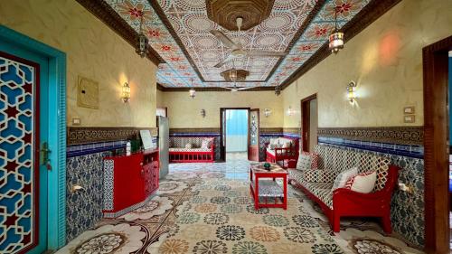 a living room with a couch and chairs and a ceiling at Villa Barba Luxor in Luxor