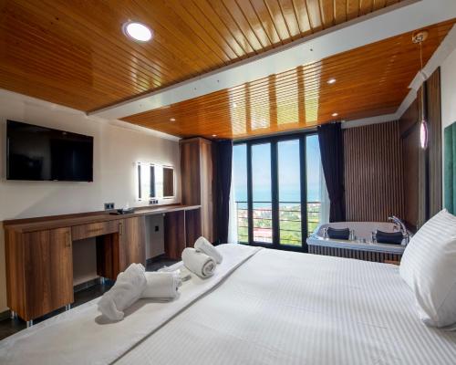 a bedroom with a large bed with towels on it at Royal Villa in Trabzon