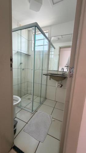 a bathroom with a glass shower and a sink at Apartmento Valencia in Franca