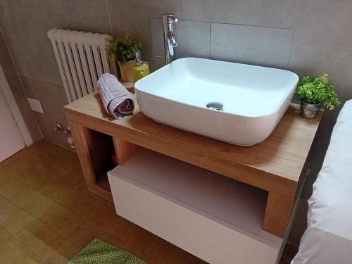 a white sink on a wooden table in a bedroom at Garda City Home Family Apartments in Garda