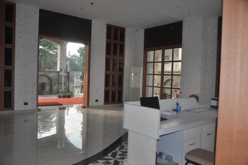 a kitchen with a desk with a laptop on it at Pahadi Convention in Rourkela