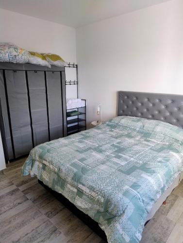 a bedroom with a bed with a quilt on it at Apartment 1 block from the sea in Mar de Ajó