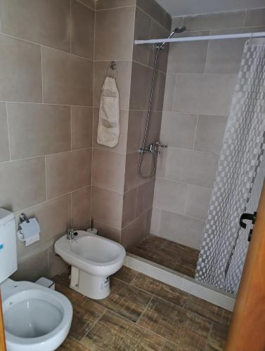 a bathroom with a toilet and a shower at Apartment 1 block from the sea in Mar de Ajó