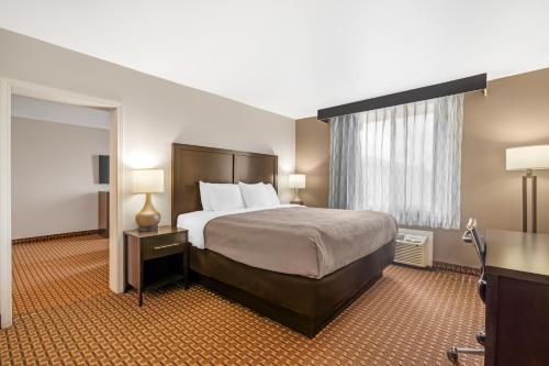 a hotel room with a bed and a window at Quality Inn & Suites Chattanooga-East Ridge in Chattanooga