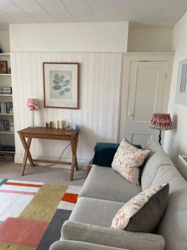 a living room with a couch and a table at Spacious comfortable flat with free parking in East Finchley, Muswell Hill & close to Alexandra Palace in London