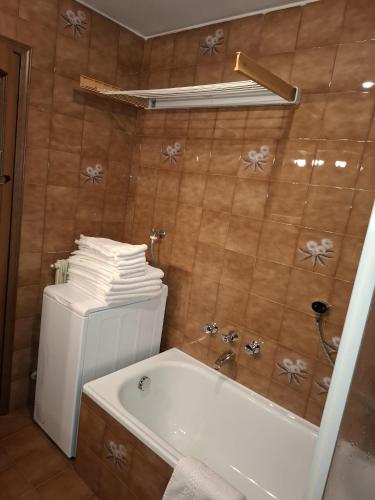 a bathroom with a tub and a toilet and a sink at Campiglio Trilocale Cima Tosa in Madonna di Campiglio