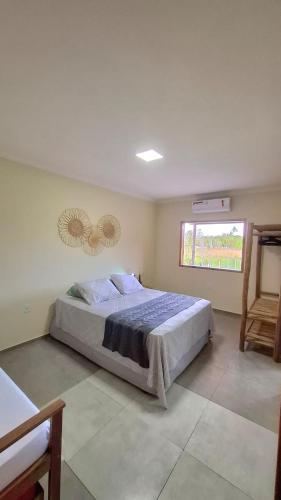 a bedroom with a large bed and a window at Casa do Brother in Prado