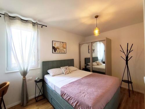 a bedroom with a bed and a large window at Nashi Garden Apartment Split with City View & Parking in Solin