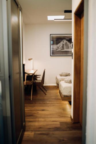 a hallway with a room with a bed and a desk at DePhazz I Wellness Clinic & Spa in Junín
