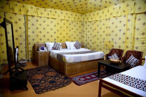 a bedroom with a bed in a room with yellow wallpaper at Royal Salma Resort A family Luxury Camp 