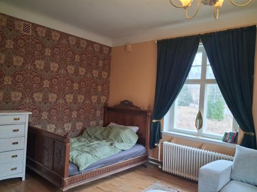 a bedroom with a bed and a window at Singel room in big house in Molkom