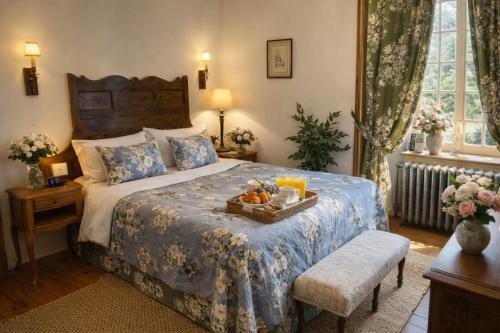 a bedroom with a bed with a tray of fruit on it at Chateau d'Isigny - Normandie - Country House in Isigny-le-Buat