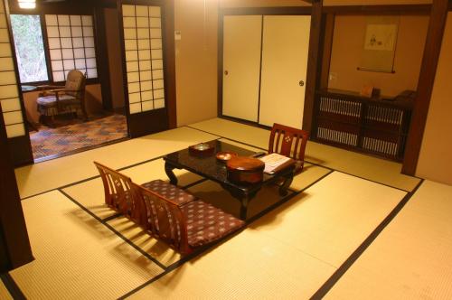 a dining room with a table and chairs in a room at Yumoto Choza in Takayama