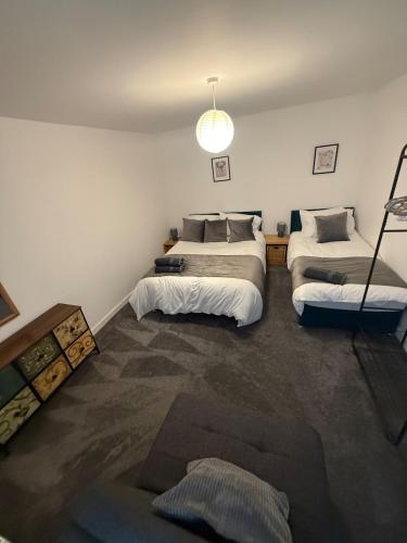 a bedroom with two beds in a room at Pool table-Pet Friendly-Beach access-Garden in Trearddur