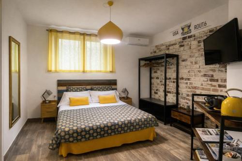 a bedroom with a bed and a brick wall at INDUSTRIAL CHIC HOUSE - Private parking in Orvieto