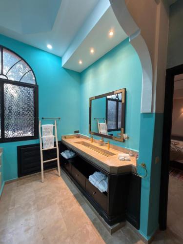 a bathroom with a large sink and a mirror at Royal Moroccan House in Marrakesh