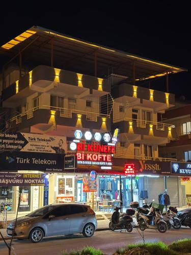 a car parked in front of a building at night at Ozan Konukevi in Hatay
