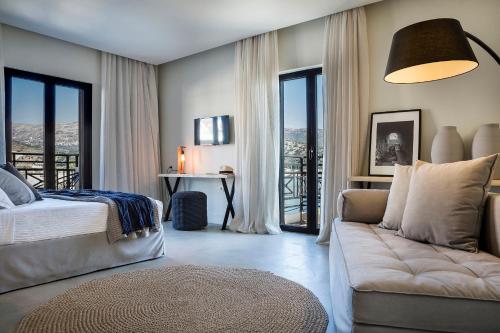 阿爾戈斯托利的住宿－凱法利尼亞格蘭德酒店，一间卧室配有一张床、一张沙发和窗户。
