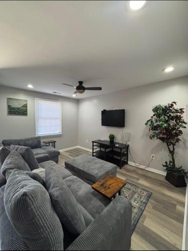 a living room with a couch and a flat screen tv at Riverside Retreat in Camden