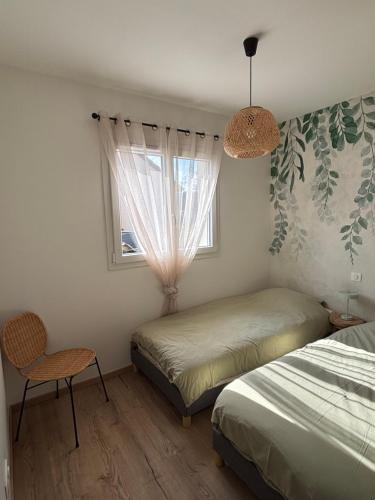 a bedroom with two beds and a window at Le Nid des Moises, pavillon neuf in Relanges