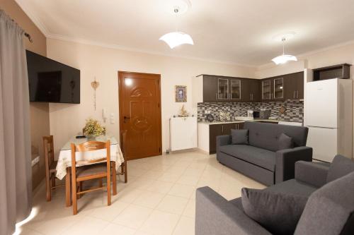 a living room with a couch and a table and a kitchen at Nikorina apts in Lefkada