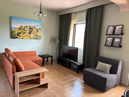 a living room with a couch and a chair at Dream Village Mani in Karvelás