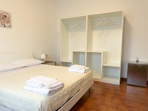 a bedroom with a bed with towels on it at Da Vinci Rooms in Vinci