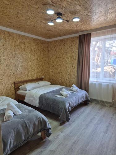 a bedroom with two beds and a window at Guest House Aspindza in Aspindza