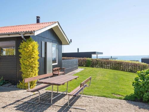 a picnic bench in front of a tiny house at 5 person holiday home in Juelsminde-By Traum in Sønderby