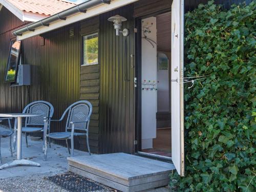 an open door to a house with chairs and a table at 5 person holiday home in Juelsminde-By Traum in Sønderby