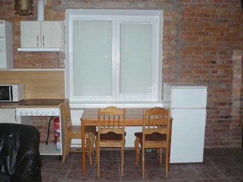 a kitchen with a table and chairs and a window at Centro bustas in Kėdainiai