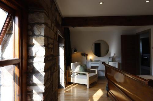 a living room with a stone wall at Stone & Sage- City Centre Luxury Courtyard Lofts in Lancaster
