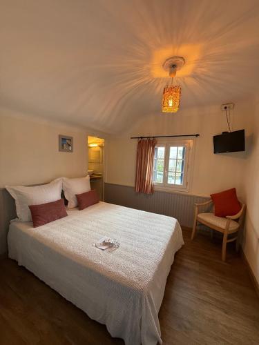 a bedroom with a large bed and a window at Matsya Hostel in Anglet