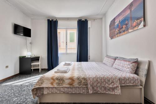 a bedroom with a bed and a desk and a window at Cozy Best Appartment in Marghera