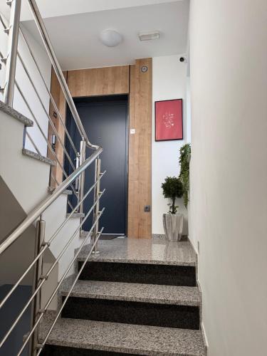a hallway with stairs leading up to a door at Luxury apartment Gabi 1 in Slavonski Brod